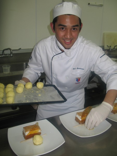 Student Carlo Buenaventura cooks up the Filipino entr&#233;e, Brazo de Mercedes Napoleon